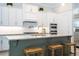 Bright kitchen with white cabinets, granite countertops, a central island with seating, and stainless steel appliances at 682 Canopy Estates Dr, Winter Garden, FL 34787