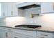 Modern kitchen with granite countertops, gas range, subway tile backsplash, and white cabinets with gold hardware at 682 Canopy Estates Dr, Winter Garden, FL 34787