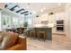 Open kitchen with a center island, stainless steel appliances, stylish barstool seating and an adjacent dining area at 682 Canopy Estates Dr, Winter Garden, FL 34787