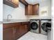 Functional laundry room featuring modern washer and dryer, granite countertops, and ample cabinet storage at 682 Canopy Estates Dr, Winter Garden, FL 34787