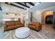 Open-concept living room with stylish wood-look tile floors, comfortable sofas, and an open connection to the modern kitchen at 682 Canopy Estates Dr, Winter Garden, FL 34787