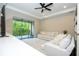 Living room features a tv, white sectional, and sliding doors to the outdoor balcony at 682 Canopy Estates Dr, Winter Garden, FL 34787