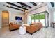 Bright, open-concept living room with stylish sofas, coffered ceilings, and sliding glass doors to the outdoor space at 682 Canopy Estates Dr, Winter Garden, FL 34787