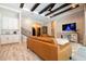 Bright, open-concept living room with stylish sofas, wood-look tile flooring and connection to the breakfast nook and kitchen at 682 Canopy Estates Dr, Winter Garden, FL 34787