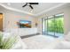 Living room features a tv, built-in shelving, and sliding doors to the outdoor balcony at 682 Canopy Estates Dr, Winter Garden, FL 34787