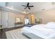 The main bedroom features dark hardwood floors, plantation shutters, a ceiling fan, and modern decor at 682 Canopy Estates Dr, Winter Garden, FL 34787