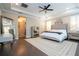 The main bedroom features dark hardwood floors, plantation shutters, a ceiling fan, and modern decor at 682 Canopy Estates Dr, Winter Garden, FL 34787