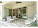 Outdoor patio with woven furniture and a sliding glass door with view to pool and backyard at 682 Canopy Estates Dr, Winter Garden, FL 34787