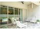 Inviting outdoor patio featuring wicker furniture and a view of the pool area through sliding glass doors at 682 Canopy Estates Dr, Winter Garden, FL 34787