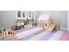Well-lit playroom featuring colorful mats and a cozy play tent for imaginative play at 682 Canopy Estates Dr, Winter Garden, FL 34787