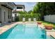 Inviting backyard with a stunning pool, sun loungers, and manicured landscaping at 682 Canopy Estates Dr, Winter Garden, FL 34787