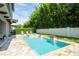 Gorgeous backyard oasis with a sparkling pool, jacuzzi, and beautifully landscaped surroundings at 682 Canopy Estates Dr, Winter Garden, FL 34787