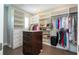 Spacious walk-in closet with custom shelving, central island, and wood floors at 682 Canopy Estates Dr, Winter Garden, FL 34787
