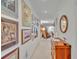 Well-lit hallway adorned with framed art, leading to a sunlit living space at 700 Melrose Ave # C22, Winter Park, FL 32789