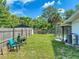 Spacious backyard features a grill, tropical landscaping, privacy fence, and screened-in pool at 720 Meadow St, Sanford, FL 32773