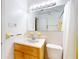This bathroom features a single vanity, tile flooring and a wall mirror at 720 Meadow St, Sanford, FL 32773