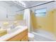 This bathroom features a bathtub, sink, a window, and yellow tile at 720 Meadow St, Sanford, FL 32773