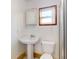 This bathroom features a pedestal sink, toilet, and stand-up shower at 720 Meadow St, Sanford, FL 32773