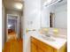 This bathroom features a single vanity, neutral wall color and wood-look flooring at 720 Meadow St, Sanford, FL 32773