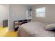 This bedroom features a bed, laminate flooring, a window, and a bookshelf at 720 Meadow St, Sanford, FL 32773