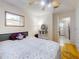 Cozy bedroom featuring wood flooring, a ceiling fan, and a window at 720 Meadow St, Sanford, FL 32773