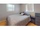 This bedroom has a bed, hardwood floors, two windows and a nightstand at 720 Meadow St, Sanford, FL 32773
