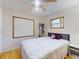 Bright bedroom featuring wood flooring, two windows, and a ceiling fan at 720 Meadow St, Sanford, FL 32773