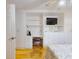 This bedroom features custom built-in cabinetry, work space, and hardwood floors at 720 Meadow St, Sanford, FL 32773