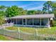 Cozy one-story home with a white picket fence and a screened-in front porch at 720 Meadow St, Sanford, FL 32773