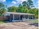 Charming ranch-style home featuring a screened-in porch and classic white picket fence at 720 Meadow St, Sanford, FL 32773