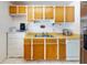 Functional kitchen with stainless steel refrigerator, bright cabinets, and white appliances at 720 Meadow St, Sanford, FL 32773