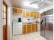 Functional kitchen with stainless steel refrigerator, bright cabinets, and white appliances at 720 Meadow St, Sanford, FL 32773