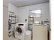 A laundry room with a modern washer and dryer, and storage shelves at 720 Meadow St, Sanford, FL 32773