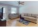 Cozy living room features hardwood floors, ceiling fan, and neutral colored sofas at 720 Meadow St, Sanford, FL 32773