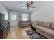 Cozy living room features hardwood floors, ceiling fan, and neutral colored sofas at 720 Meadow St, Sanford, FL 32773