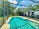 Backyard with a screened pool, patio area, and partially fenced yard at 720 Meadow St, Sanford, FL 32773
