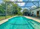 Beautiful backyard pool features clear blue water in a screened enclosure at 720 Meadow St, Sanford, FL 32773