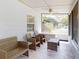 Inviting screened-in porch furnished with stylish wicker furniture and a ceiling fan at 720 Meadow St, Sanford, FL 32773