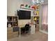 Cozy bedroom with a large television, cube storage shelves, and a charming chandelier at 813 Greybull Run, Lake Mary, FL 32746