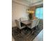 Modern dining room with textured walls, a contemporary light fixture, and comfortable upholstered chairs at 813 Greybull Run, Lake Mary, FL 32746