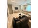 Bright living room with a comfortable sofa, entertainment center, and modern massage chair at 813 Greybull Run, Lake Mary, FL 32746
