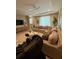 Spacious living room with plush sectional sofa, tray ceiling, and neutral color palette at 813 Greybull Run, Lake Mary, FL 32746