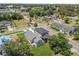 Aerial view of two homes in a neighborhood setting featuring mature trees and nearby streets, and more homes at 817 E Mcdonald Ave, Eustis, FL 32726