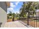 Back porch offers outdoor views and features a black metal railing, perfect for enjoying nature and relaxation at 817 E Mcdonald Ave, Eustis, FL 32726