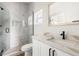 Updated bathroom showcasing a sleek glass shower, white vanity with modern fixtures, and a framed mirror above at 817 E Mcdonald Ave, Eustis, FL 32726