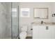 Modern bathroom featuring a glass shower, white vanity, and stylish marble-look countertop and matching shower tile at 817 E Mcdonald Ave, Eustis, FL 32726