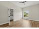 Open bedroom with wood-look floors, adjoining bathroom, and natural light from the window at 817 E Mcdonald Ave, Eustis, FL 32726