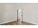 Bright bedroom with wood-look floors and doorway at 817 E Mcdonald Ave, Eustis, FL 32726