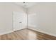 Well-lit bedroom with wood-look floors, closet, and natural light from the window at 817 E Mcdonald Ave, Eustis, FL 32726
