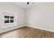 Cozy bedroom with wood-look floors and natural light from a large window at 817 E Mcdonald Ave, Eustis, FL 32726